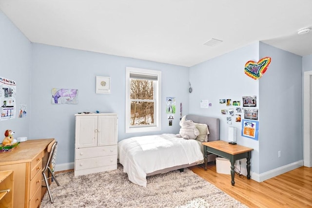 bedroom with baseboards and light wood-style flooring
