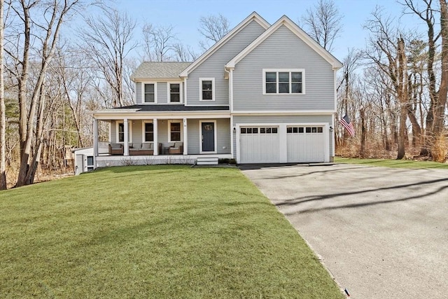 view of front facade featuring covered porch, an attached garage, driveway, and a front yard