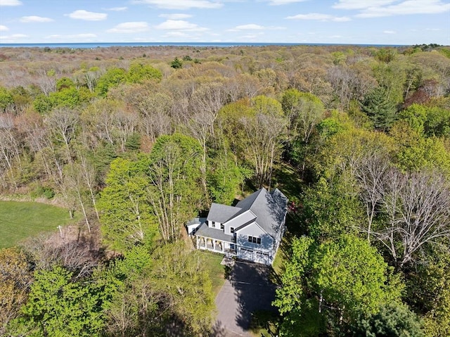 birds eye view of property featuring a view of trees