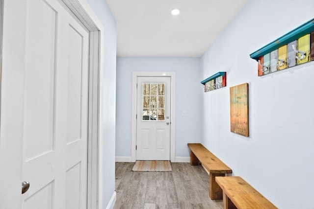 entryway with recessed lighting, baseboards, and light wood finished floors