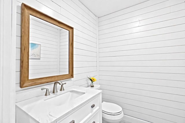 half bathroom with vanity and toilet