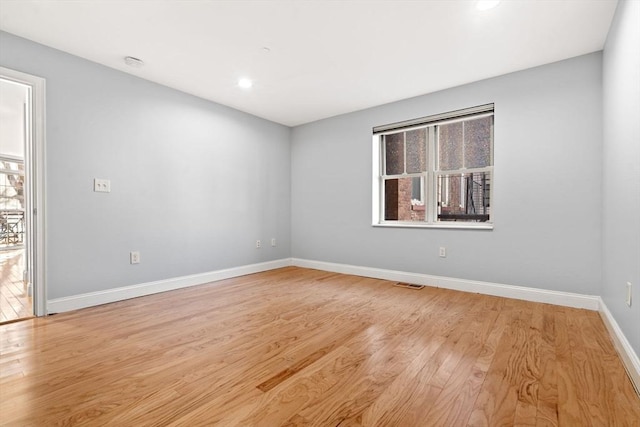 unfurnished room with light wood-type flooring