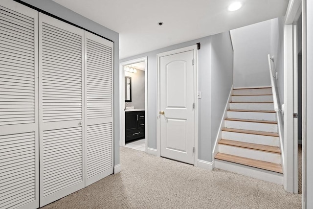 stairway featuring carpet flooring