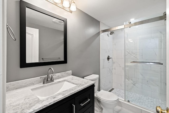 bathroom with vanity, toilet, and an enclosed shower