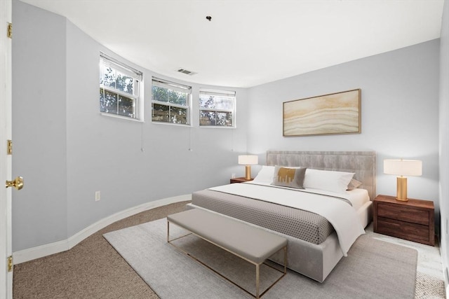 bedroom featuring light carpet