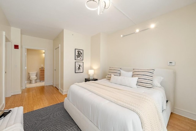 45 Province St Unit 1103, Boston, MA 02108 - bedroom featuring light wood-style flooring, baseboards, and ensuite bathroom