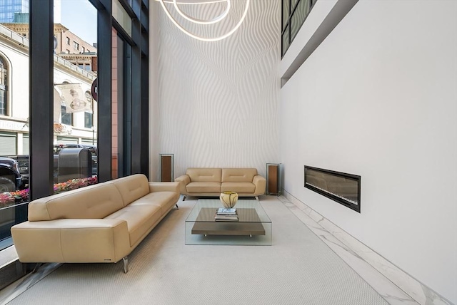 45 Province St Unit 1103, Boston, MA 02108 - living room with marble finish flooring, a towering ceiling, and a glass covered fireplace
