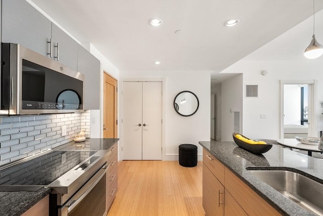 45 Province St Unit 1103, Boston, MA 02108 - kitchen featuring stainless steel appliances, light wood-style flooring, decorative backsplash, recessed lighting, and modern cabinets