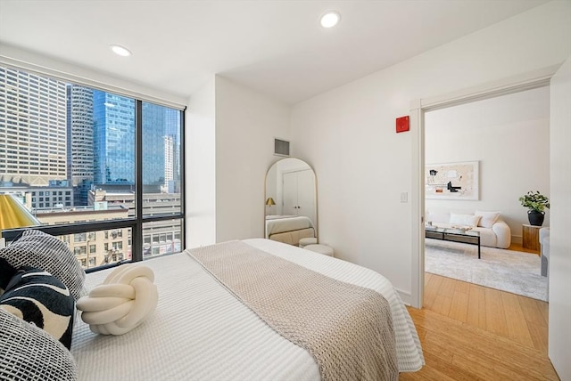 45 Province St Unit 1103, Boston, MA 02108 - bedroom featuring a wall of windows, wood finished floors, and recessed lighting