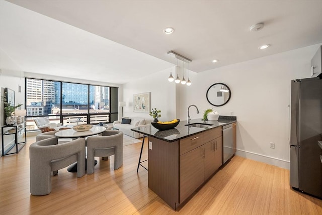 45 Province St Unit 1103, Boston, MA 02108 - kitchen with a sink, appliances with stainless steel finishes, open floor plan, a peninsula, and light wood-type flooring