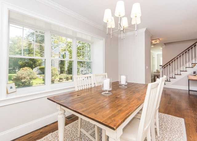 dining area featuring wood finished floors, a chandelier, stairway, ornamental molding, and baseboards