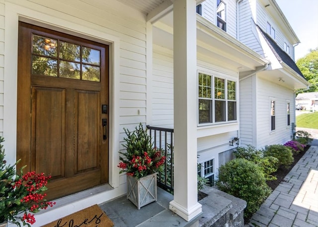view of exterior entry with a porch
