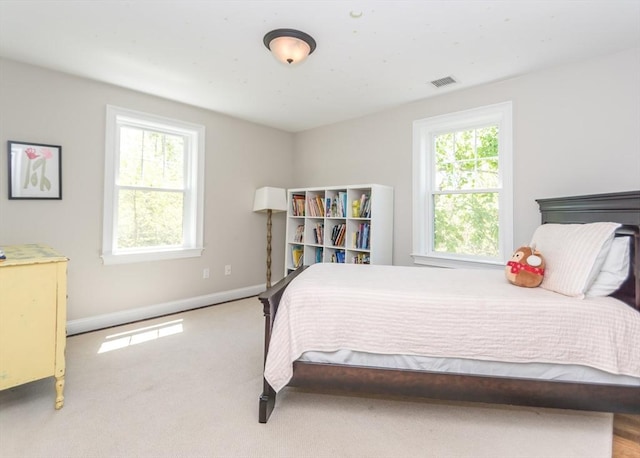 bedroom with baseboards and carpet