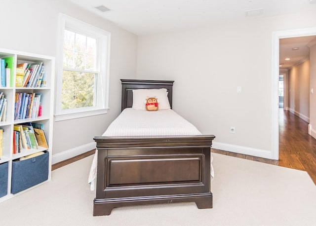 bedroom featuring wood finished floors and baseboards