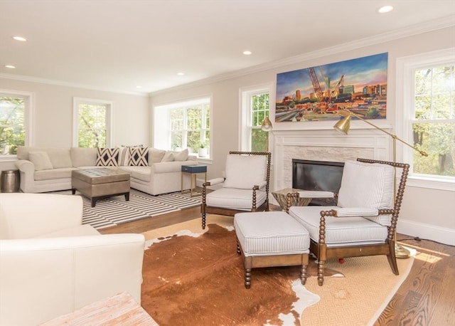 living room with wood finished floors, ornamental molding, healthy amount of natural light, and recessed lighting
