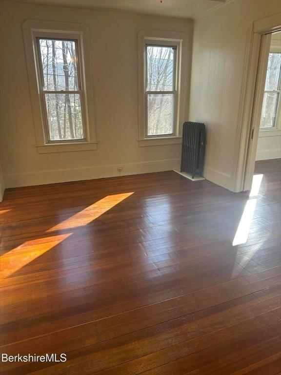57 Beacon St, North Adams, MA 01247 - unfurnished room featuring baseboards, healthy amount of natural light, and dark wood-style floors