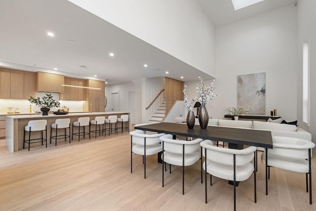 44 Robeson St Unit 44B, Boston, MA 02130 - dining area with stairs, recessed lighting, light wood finished floors, a towering ceiling, and a skylight