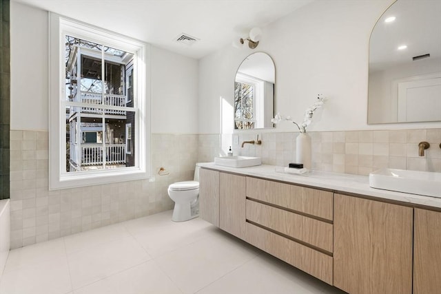 44 Robeson St Unit 44B, Boston, MA 02130 - full bathroom featuring tile walls, toilet, tile patterned floors, double vanity, and wainscoting
