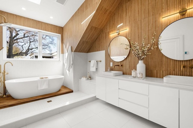 44 Robeson St Unit 44B, Boston, MA 02130 - bathroom with tile patterned flooring, a freestanding tub, double vanity, lofted ceiling, and wood walls