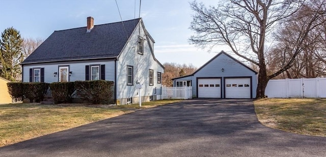 view of side of property with a detached garage, fence, an outdoor structure, a shingled roof, and a chimney