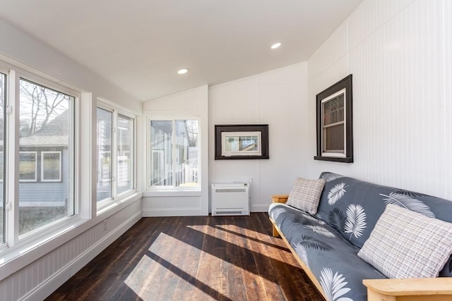 sunroom / solarium with vaulted ceiling, heating unit, and a healthy amount of sunlight