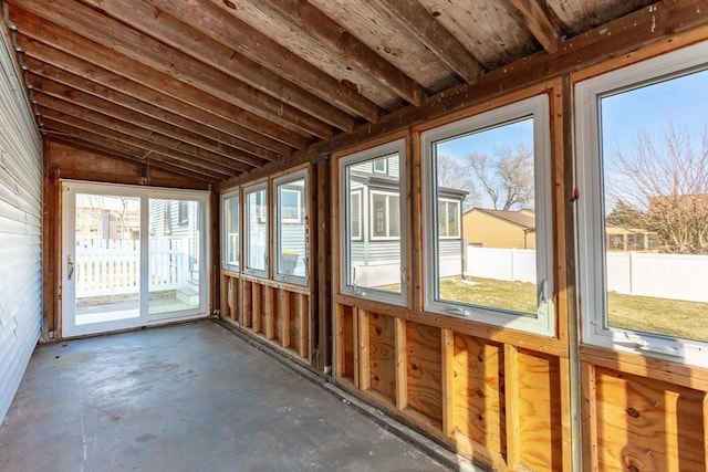 unfurnished sunroom with lofted ceiling