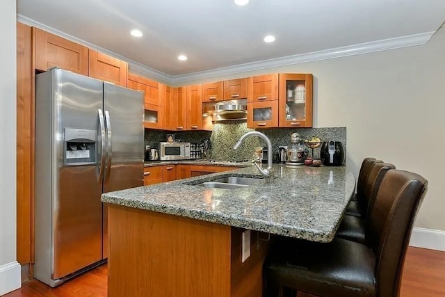 19 Bay State Rd Unit 1, Boston, MA 02215 - kitchen with stainless steel appliances, a peninsula, brown cabinets, a sink, and glass insert cabinets