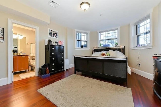 19 Bay State Rd Unit 1, Boston, MA 02215 - bedroom featuring wood finished floors, baseboards, radiator, and ensuite bathroom