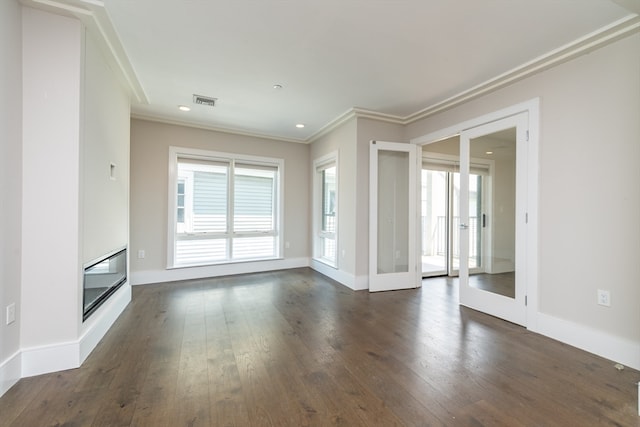 unfurnished living room featuring ornamental molding and dark wood-type flooring