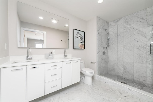 bathroom featuring vanity, toilet, and a shower with door