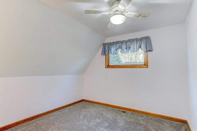 additional living space featuring carpet floors, baseboards, vaulted ceiling, and visible vents