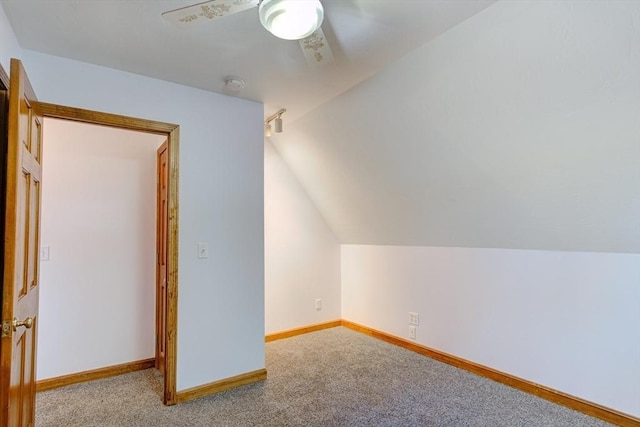additional living space featuring carpet floors, a ceiling fan, baseboards, and lofted ceiling