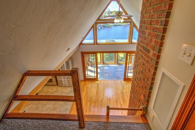 bonus room featuring visible vents, wood finished floors, and vaulted ceiling
