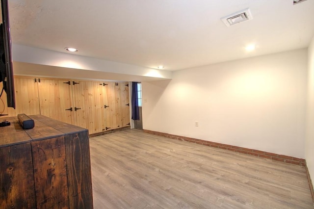 interior space with baseboards, recessed lighting, wood finished floors, and visible vents