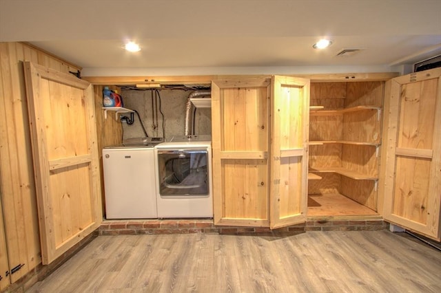 laundry area with washer and dryer, laundry area, and wood finished floors