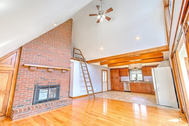 unfurnished living room with a fireplace, baseboards, high vaulted ceiling, a ceiling fan, and light wood finished floors