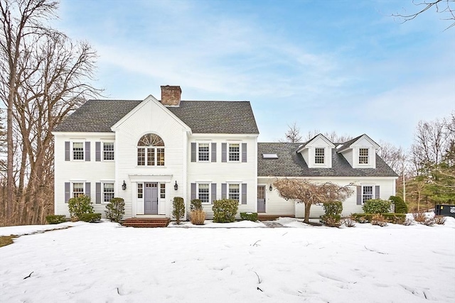 colonial-style house with a shingled roof and a chimney