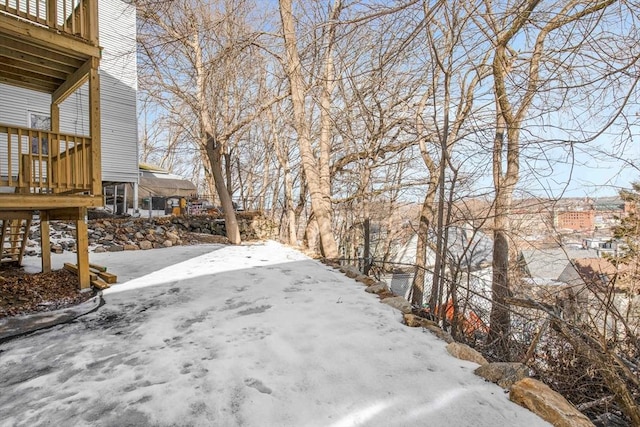 snowy yard with a deck