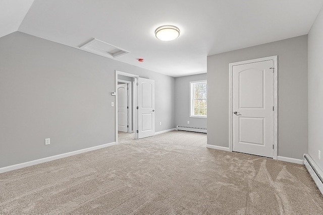 empty room with light carpet, lofted ceiling, and a baseboard heating unit