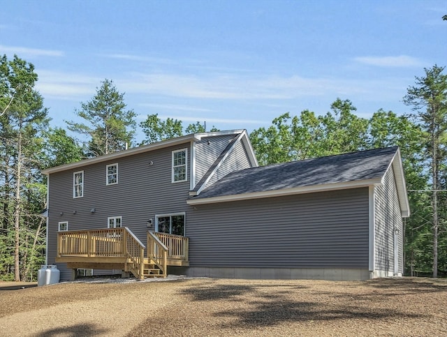 back of property featuring a wooden deck