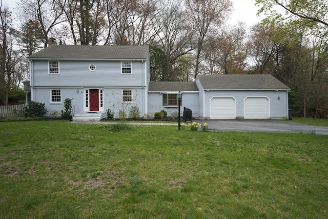 9 Brucewood, Acton, MA 01720 - colonial home featuring a garage, a chimney, a front lawn, and aphalt driveway