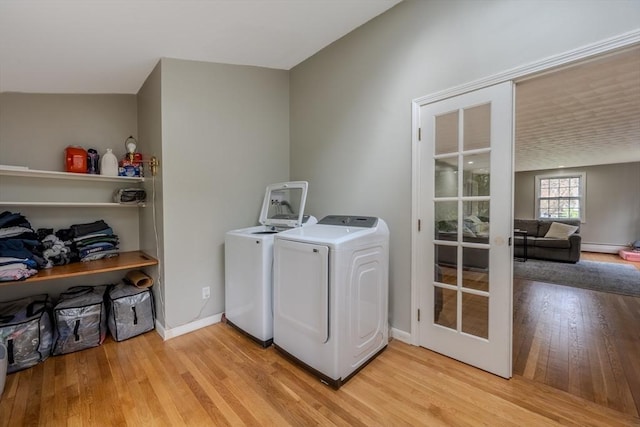 9 Brucewood, Acton, MA 01720 - clothes washing area featuring light wood-style floors, laundry area, baseboards, and washing machine and clothes dryer
