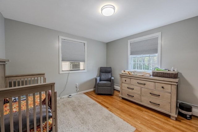 9 Brucewood, Acton, MA 01720 - bedroom with baseboards, cooling unit, baseboard heating, and light wood-style floors