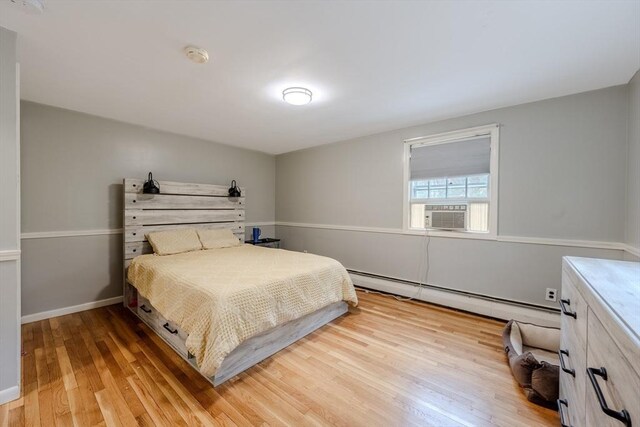 9 Brucewood, Acton, MA 01720 - bedroom with baseboards, cooling unit, baseboard heating, and light wood-type flooring