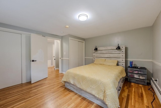 9 Brucewood, Acton, MA 01720 - bedroom featuring multiple closets, wood finished floors, and baseboard heating