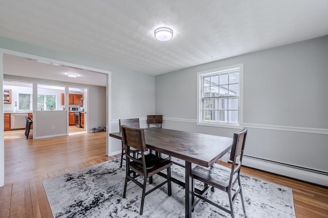 9 Brucewood, Acton, MA 01720 - dining space with light wood-style floors, plenty of natural light, and baseboard heating
