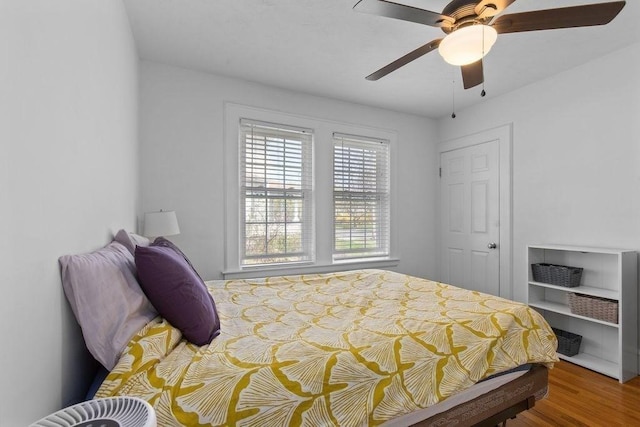 bedroom with a ceiling fan and wood finished floors
