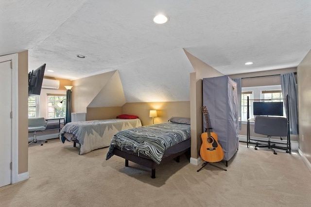 bedroom featuring baseboards, carpet, vaulted ceiling, and a wall mounted air conditioner