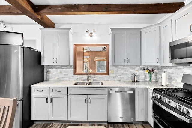 kitchen with sink, beamed ceiling, stainless steel appliances, light stone countertops, and backsplash