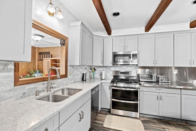 kitchen featuring sink, tasteful backsplash, appliances with stainless steel finishes, beam ceiling, and light stone countertops